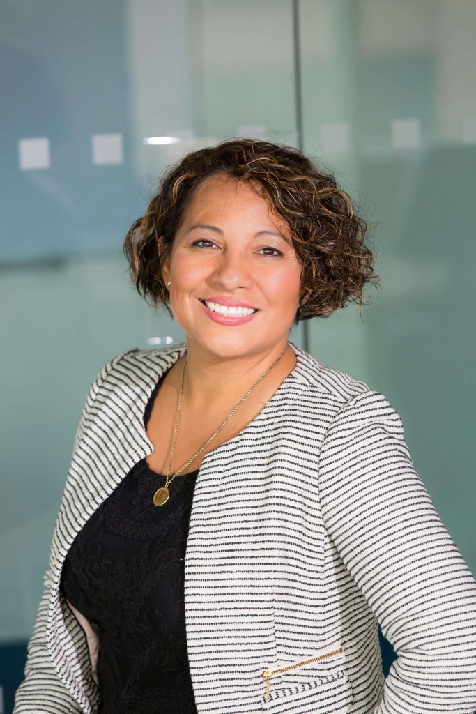 Attie Hope, a BABCP accredited anxiety therapist in London, smiling warmly in a professional headshot.